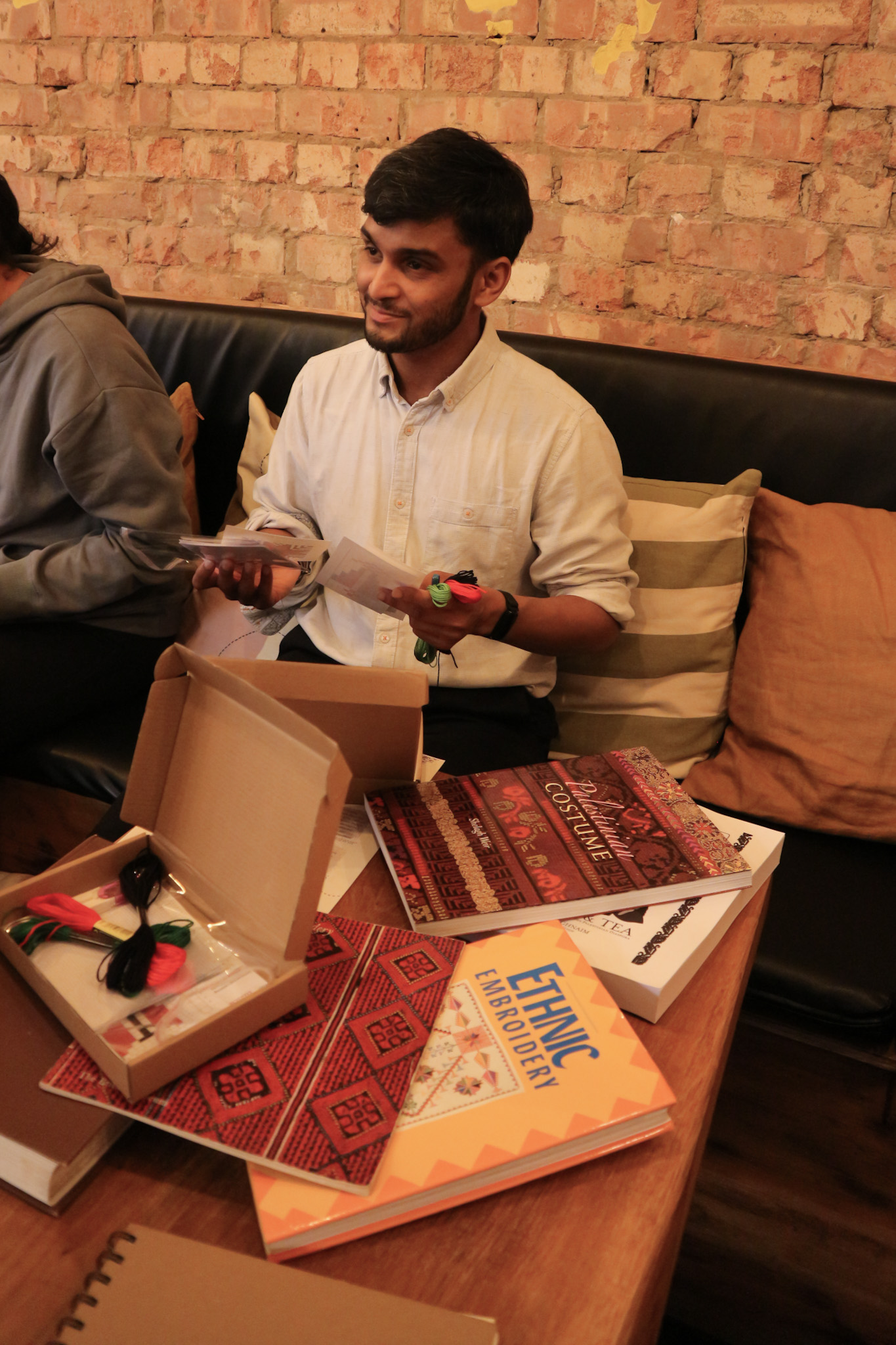 Afsar Ali, founder of Muted Healing delivering a Tatreez workshop.